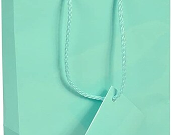 May include: A light blue gift bag with a matching tag. The bag has a rope handle and is made of paper.