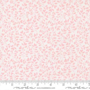 May include: White fabric with a repeating pattern of pink leaves and heart shapes. The fabric has a ruler printed along the bottom edge with the word "moda" and website address.