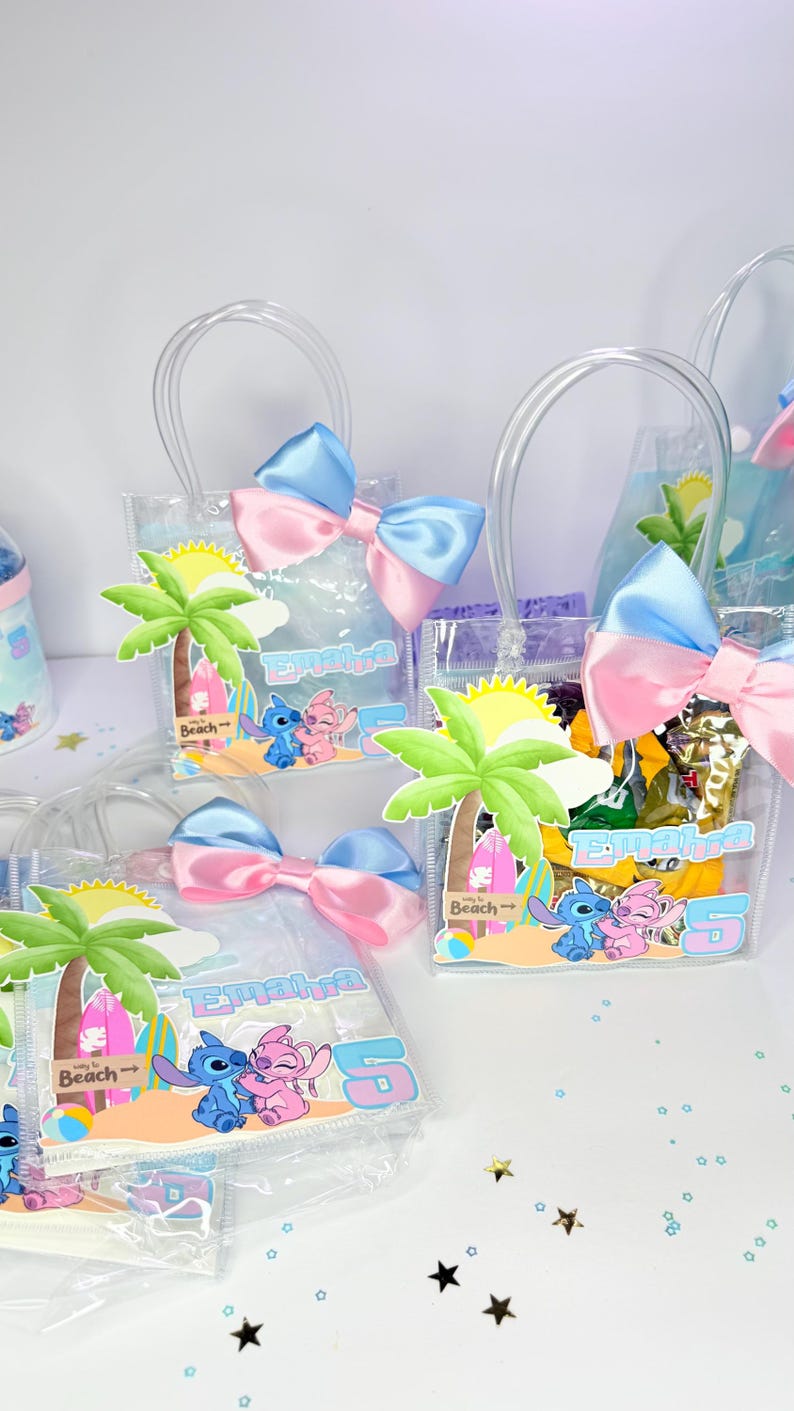 May include: Clear plastic gift bags with blue and pink satin bows. Each bag features a palm tree, the characters Stitch and Angel, and the name "Emalha". The bags are filled with treats and have clear handles.