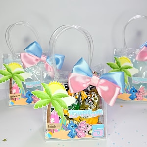 May include: Clear plastic gift bags with blue and pink bows, each featuring a beach-themed design with cartoon characters. The bags have clear handles and are filled with yellow and brown items. The bags have a label with a name and the number 5.