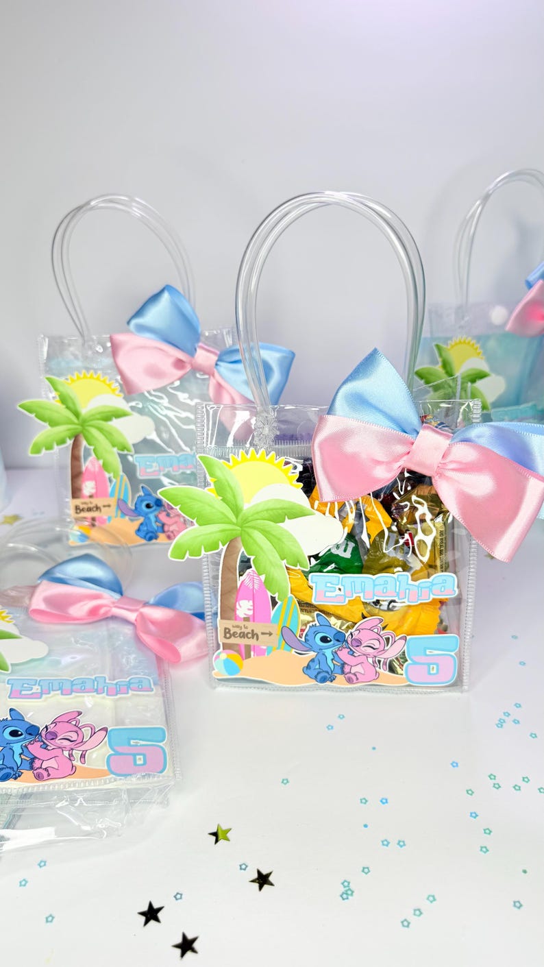 May include: Clear plastic favor bags with blue and pink bows. Each bag features a beach-themed graphic with palm trees, Stitch and Angel characters, and the name "Emahra" with the number "5".