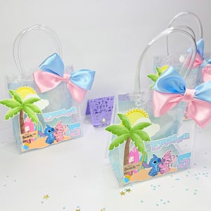 May include: Clear plastic favor bags with blue and pink bows. Each bag features a beach scene with palm trees, Stitch and Angel characters, and the name "Emaira" with the number "5".