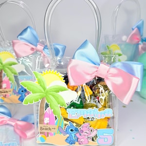 May include: Clear plastic favor bags with blue and pink bows. Each bag features a beach-themed design with cartoon characters and the number 5. The bags have clear handles and are filled with treats.