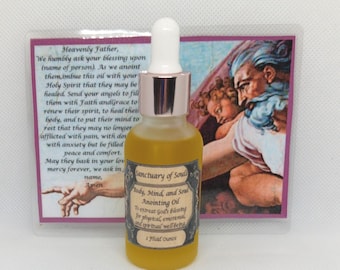 May include: A small amber glass bottle with a gold cap and a white dropper. The bottle is labeled "Sanctuary of Souls Body, Mind and Soul Anointing Oil To entreat God's blessing for physical, emotional and spiritual wellbeing 1 Fluid Ounce". The bottle is in front of a card with a religious image and text.