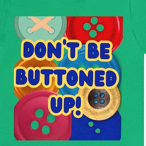 May include: A green t-shirt with a colorful button design and the text "Don't be buttoned up!"
