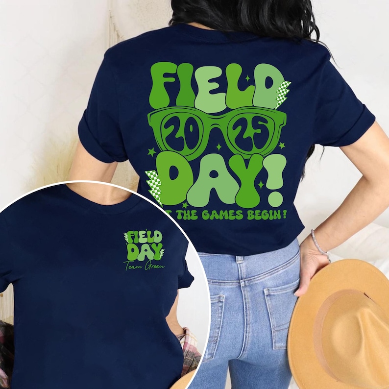 May include: Navy blue t-shirt with a green graphic that says "Field Day 2025" with sunglasses and the text "Let the games begin!" on the back. The front of the shirt has a smaller green graphic that says "Field Day Team Green".