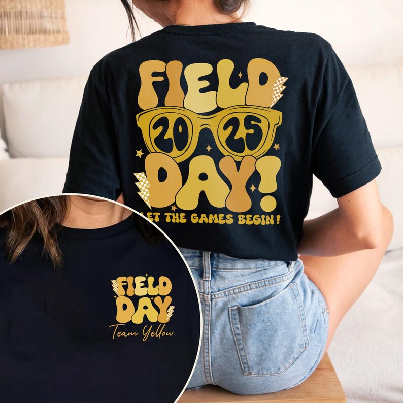 May include: Black t-shirt with a gold graphic that says "Field Day! 2025 Let the games begin!" on the back. The front of the shirt has a smaller gold graphic that says "Field Day Team Yellow".