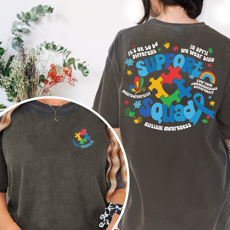 May include: Two dark gray t-shirts with a blue, red, yellow, and green puzzle piece design. The back of one shirt says "Support Squad Autism Awareness" and the front of the other shirt says "Team Charlie".
