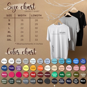 May include: A size chart for unisex t-shirts, with measurements in inches, and a color chart with various hues. The chart includes sizes S to 3XL, with width and length measurements. Three t-shirts hang on wooden hangers.