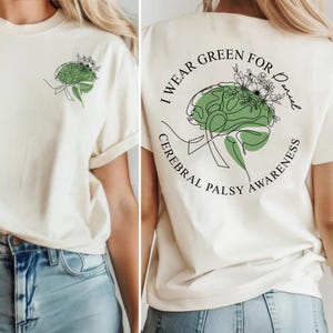 Cerebral palsy awareness shirt featuring “I Wear Green” text with a green brain illustration and line art details. CP awareness t-shirt designed to support cerebral palsy warriors, families, and advocates, shown worn casually, highlighting a meaningful awareness month apparel choice.