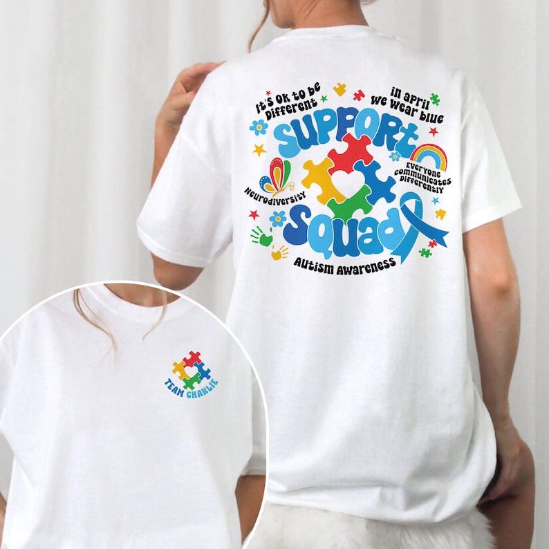 May include: White t-shirt with a blue ribbon and puzzle pieces on the back. The text on the back reads "Support Squad Autism Awareness". The front of the shirt has a small puzzle piece with the text "Team Charlie".
