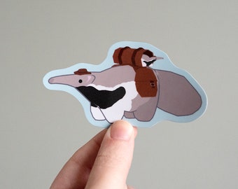 May include: A sticker featuring a cartoon anteater wearing a hat and carrying a small bird on its back. The anteater is brown and white, and the bird is brown and yellow. The sticker is on a light blue background.
