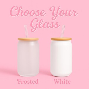 May include: Two glass tumblers with bamboo lids and clear straws are displayed against a pink background. One tumbler is frosted, and the other is white. The text "Choose Your Glass" is above the tumblers, and the words "Frosted" and "White" are below.