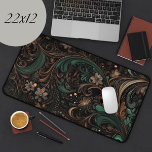 May include: A black, green, and gold floral patterned mousepad with a white computer mouse on top. The mousepad is 22 inches by 12 inches.