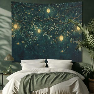 May include: A tapestry featuring a dark green forest scene with glowing lights hanging from the branches. The tapestry is hung above a white bed with a green throw blanket.