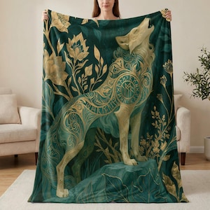 May include: A rectangular throw blanket featuring a deep emerald green background with a large, golden, stylised wolf howling while standing on a rock. The wolf is decorated with intricate swirling patterns and runic symbols amidst golden floral motifs.