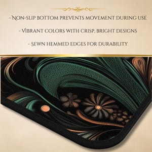 May include: A black mouse pad with a green and orange abstract floral design. The mouse pad has a non-slip bottom and sewn hemmed edges.