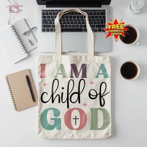 May include: Cream-colored tote bag with the text "I AM A child of GOD" in various colors. The bag has a simple design with a cross symbol in the word "GOD". The bag has two handles and is made of a sturdy fabric.