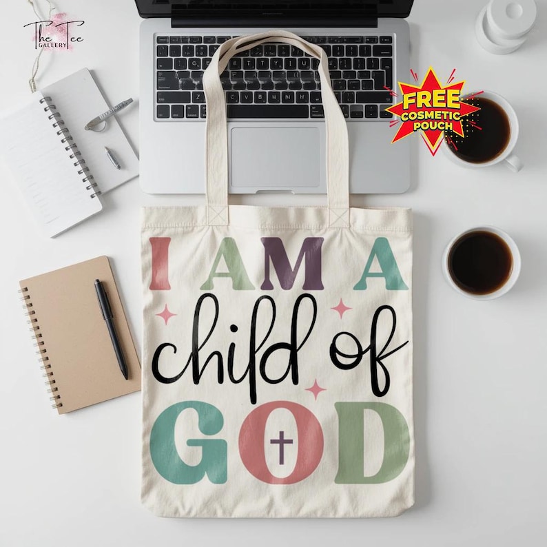 May include: Cream-colored tote bag with the text "I AM A child of GOD" in various colors. The bag has a simple design with a cross symbol in the word "GOD". The bag has two handles and is made of a sturdy fabric.