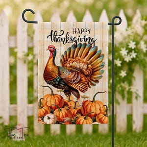 May include: Thanksgiving garden flag with a vibrant turkey and pumpkins. The flag displays the words "Happy Thanksgiving" on a wooden backdrop. The flag is mounted on a black metal stand, perfect for outdoor decoration.