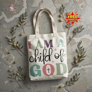 May include: Cream-colored tote bag with the text "I AM A child of GOD" in colorful letters. The bag has two handles and is decorated with olive branches and a "FREE COSMETIC POUCH" sticker.
