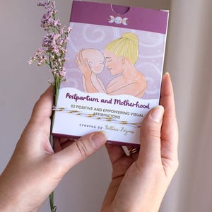 May include: A deck of affirmation cards titled "Postpartum and Motherhood" with an illustration of a mother and baby. The box is purple and white, with the text "52 Positive and Empowering Visual Affirmations" and the creator's name.