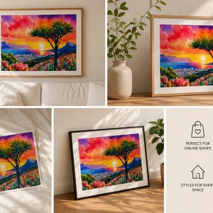 K&ouml;nnte beinhalten: Aquarell-Landschaftskunst-Druck mit einem lebendigen Sonnenuntergang &uuml;ber einer Stadt und Bergen. Ein Baum steht als Silhouette im Vordergrund, mit bunten Blumen. Das Kunstwerk wird in verschiedenen gerahmten Formaten pr&auml;sentiert.
