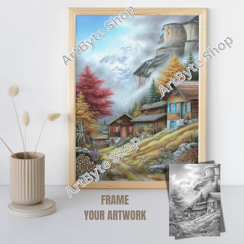 May include: A framed landscape art print depicting a mountain village scene with colorful autumn trees and houses. The artwork is in a light wooden frame. A smaller black and white print of the same scene is included. The text "FRAME YOUR ARTWORK" is at the bottom.
