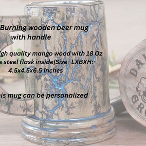 May include: A wooden beer mug featuring fractal burning patterns with blue resin inlay, a handle, and an 18 oz stainless steel interior. The mug measures 4.5x4.5x6.5 inches. The base is engraved with the text DAVID GROOMSMAN and two beer mugs.
