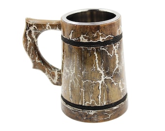 May include: A wooden beer mug with a stainless steel interior. The mug has a brown and white crackle finish, a curved handle, and is accented with black rope. The top and bottom are trimmed with silver metal.