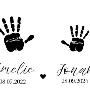 May include: Black handprints with the names Amelie and Jonah and their birthdates 08.07.2022 and 28.09.2024.