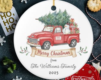 May include: White ceramic Christmas ornament featuring a red truck carrying a Christmas tree, gifts, and a snowman. The ornament has the text "Merry Christmas from The Williams Family 2025". Includes a gold string for hanging.