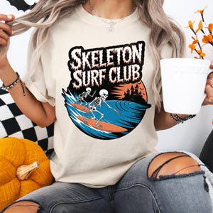 Comfort Colors® Skeleton Surf Club Shirt – Funny Halloween Beach Tee with Spooky Skeletons Surfing, Coastal Goth Shirt