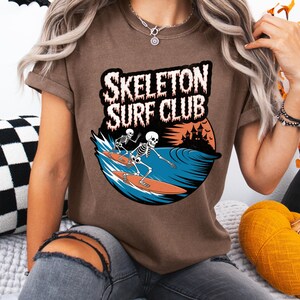 Comfort Colors® Skeleton Surf Club Shirt – Funny Halloween Beach Tee with Spooky Skeletons Surfing, Coastal Goth Shirt