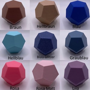 May include: Nine different colored geometric shapes, each with a unique texture. The colors are brown, light brown, blue, light blue, blue with glitter, gray-blue, pink, light pink, and purple.