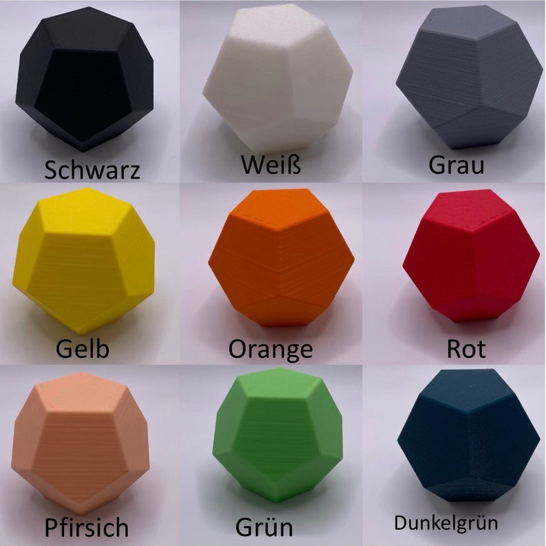May include: Nine geometric shapes in various colors, including black, white, gray, yellow, orange, red, peach, green, and dark green. Each shape is a 3D dodecahedron.