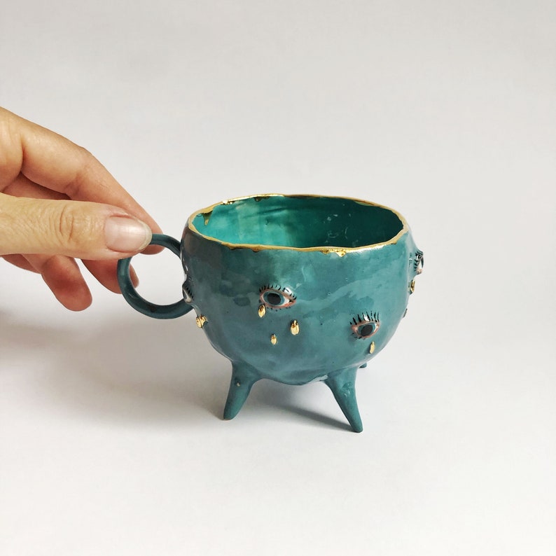 Turquoise and gold ceramic mug, Handmade ceramic tea cup with legs, Ceramic eye tears motif, Eclectic decorative mug, Artistic coffee mug