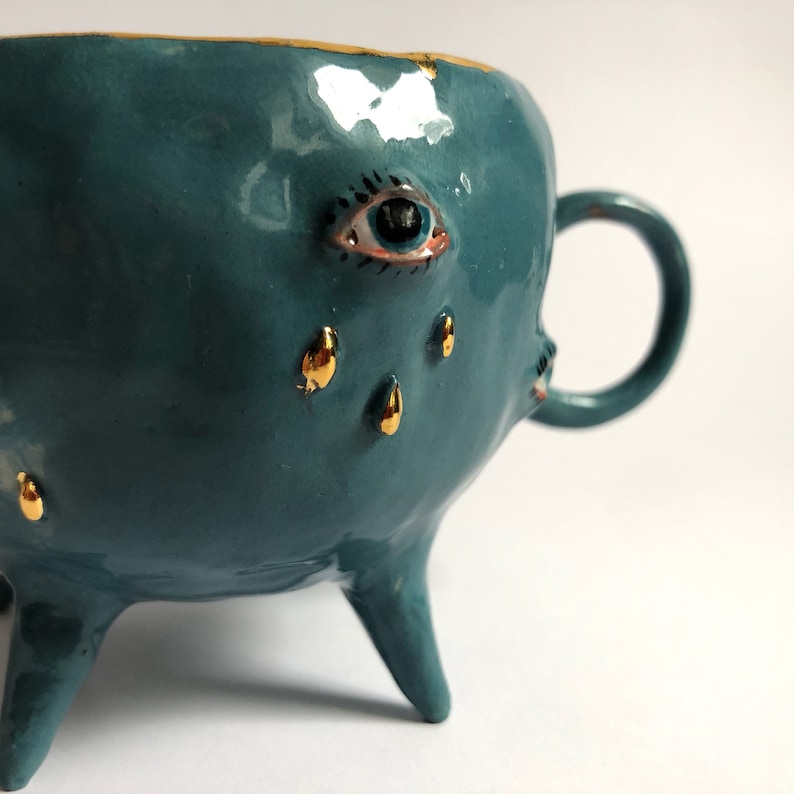 Turquoise and gold ceramic mug, Handmade ceramic tea cup with legs, Ceramic eye tears motif, Eclectic decorative mug, Artistic coffee mug