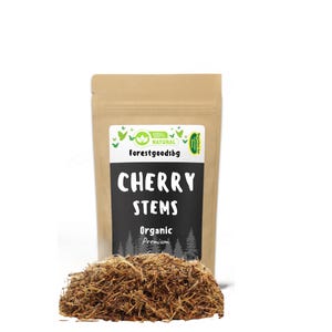 May include: A brown paper bag with a label that says "100% NATURAL forestgoodsbg" and "CHERRY STEMS Organic Premium Quality". The bag is filled with dried cherry stems.