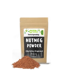 May include: A brown paper packet of nutmeg powder, labelled "Nutmeg Powder" and "(Myristica Fragrans)". A small pile of brown powder sits in front of the packet. The label also says "Forestgoodsbg".