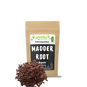 May include: A brown paper bag with a label that says "100% NATURAL Forestgoods.bg" and "MADDER ROOT Organic Rubia Tinctorum". The bag contains dried red madder root.