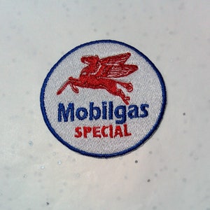 May include: Embroidered patch featuring the Mobilgas logo. The patch is circular with a white background, a blue border, and the words "Mobilgas SPECIAL" in blue and red. A red Pegasus is in the center.