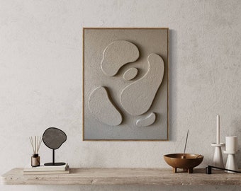 May include: A framed abstract art print with a textured, beige background and raised, organic shapes. The print is displayed on a shelf with a black mirror, a brown incense burner, and two white candlesticks.