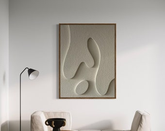 May include: A white couch with a wooden side table and a black bowl with a rope handle. A framed abstract art print with a white background and brown frame hangs on the wall behind the couch.