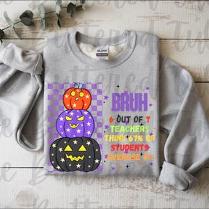 May include: A gray sweatshirt with a stacked pumpkin design. The pumpkins are orange, purple, and black with jack-o'-lantern faces. Text on the shirt reads "BRUH" and other phrases about teachers and students. A fun Halloween-themed top.