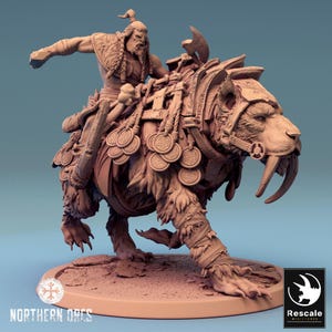 May include: A detailed miniature figurine of a warrior riding a large, fierce-looking beast. The warrior is wearing armor and wielding a weapon, while the beast has a fierce expression and sharp teeth. The figurine is painted in a muted brown color, giving it a realistic look.