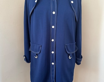 May include: A navy blue long-sleeved shirt with white stitching and buttons. The shirt has two pockets on the front and a collar.