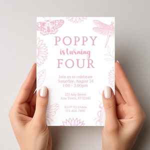 May include: A white invitation card with pink floral and insect illustrations is held by two hands. The text reads "POPPY is turning FOUR" with event details. The card is for a birthday celebration.