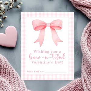 May include: A Valentine's Day card with a pink bow illustration on a pink gingham background. The card reads "Wishing you a bow-u-tiful Valentine's Day!" with a space for a friend's name. A pink heart and a pink scarf are also in the image.