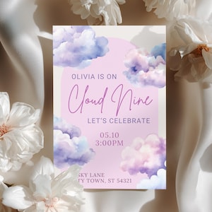 May include: A pastel invitation card with a cloud theme. The card features the text "OLIVIA IS ON Cloud Nine LET'S CELEBRATE" in a whimsical font, along with the date and time. The design includes watercolor-style clouds in shades of purple and blue.
